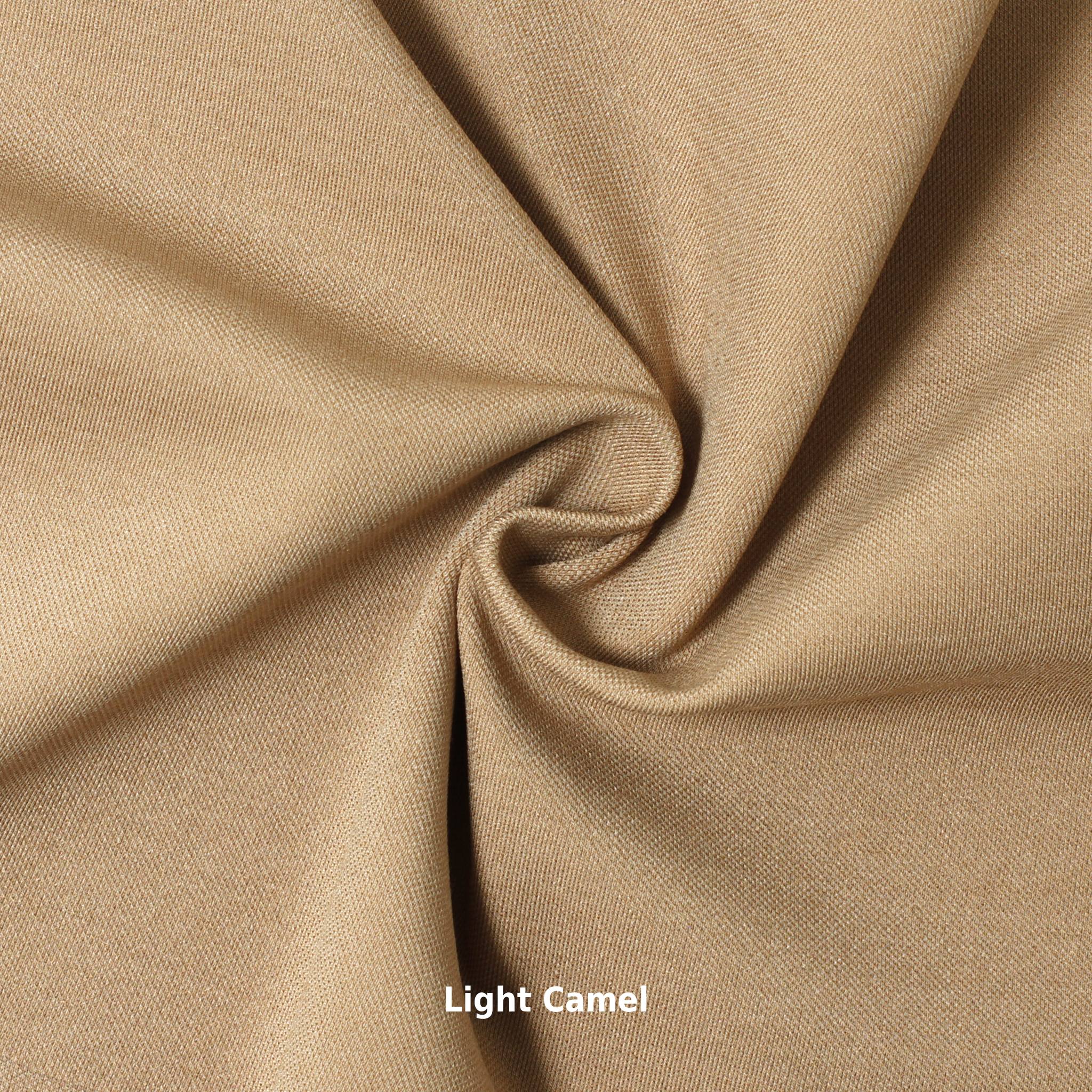 A swatch of knit pique fabric in a light camel color, showing the texture and weave of the material.