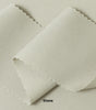A swatch of knit pique fabric in a light beige color, showing the texture and weave of the material.