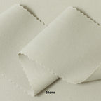 A swatch of knit pique fabric in a light beige color, showing the texture and weave of the material.